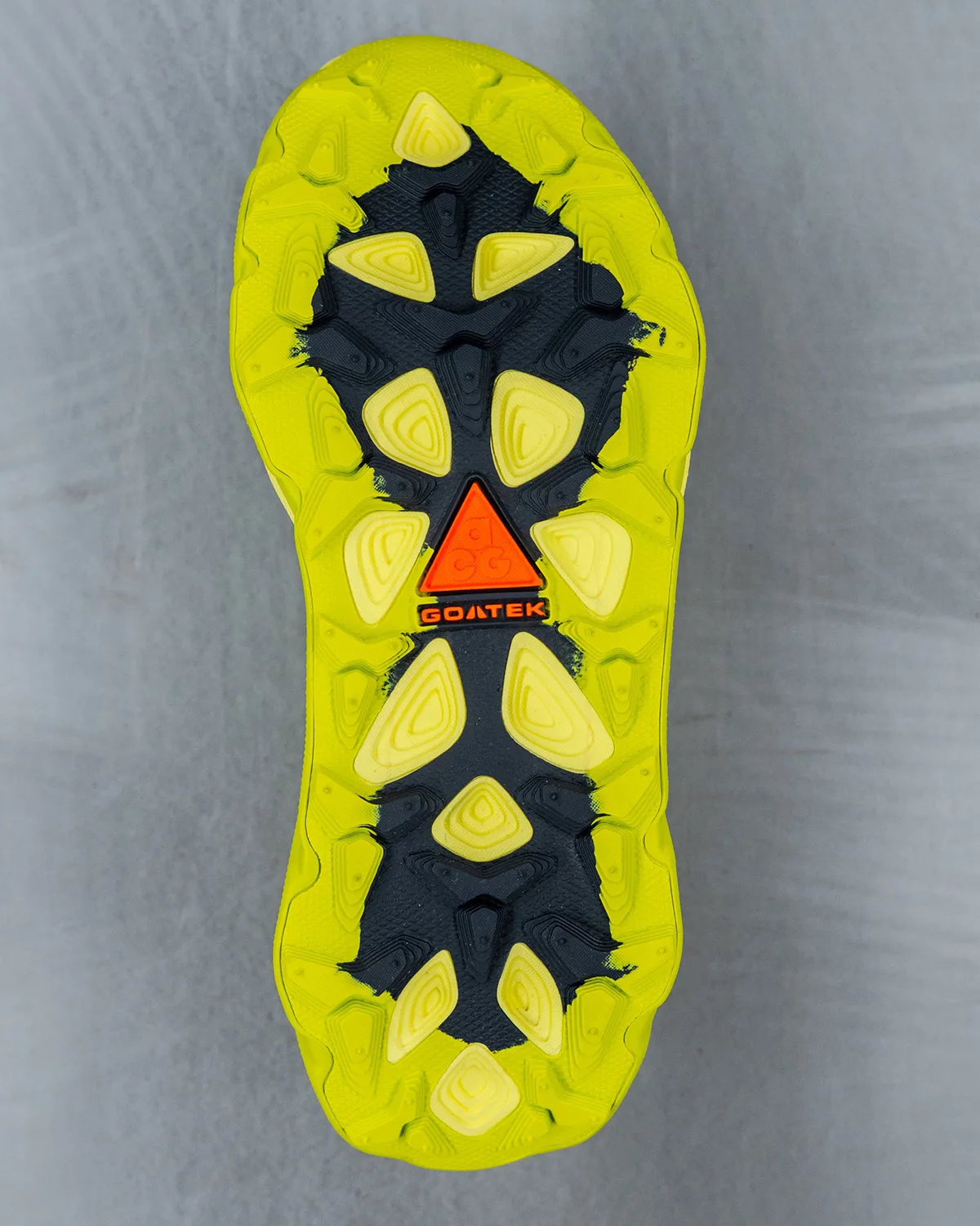 Outsole close-up, yellow-green tread with orange ACG triangle and Goatek text, Nike ACG Picklejus