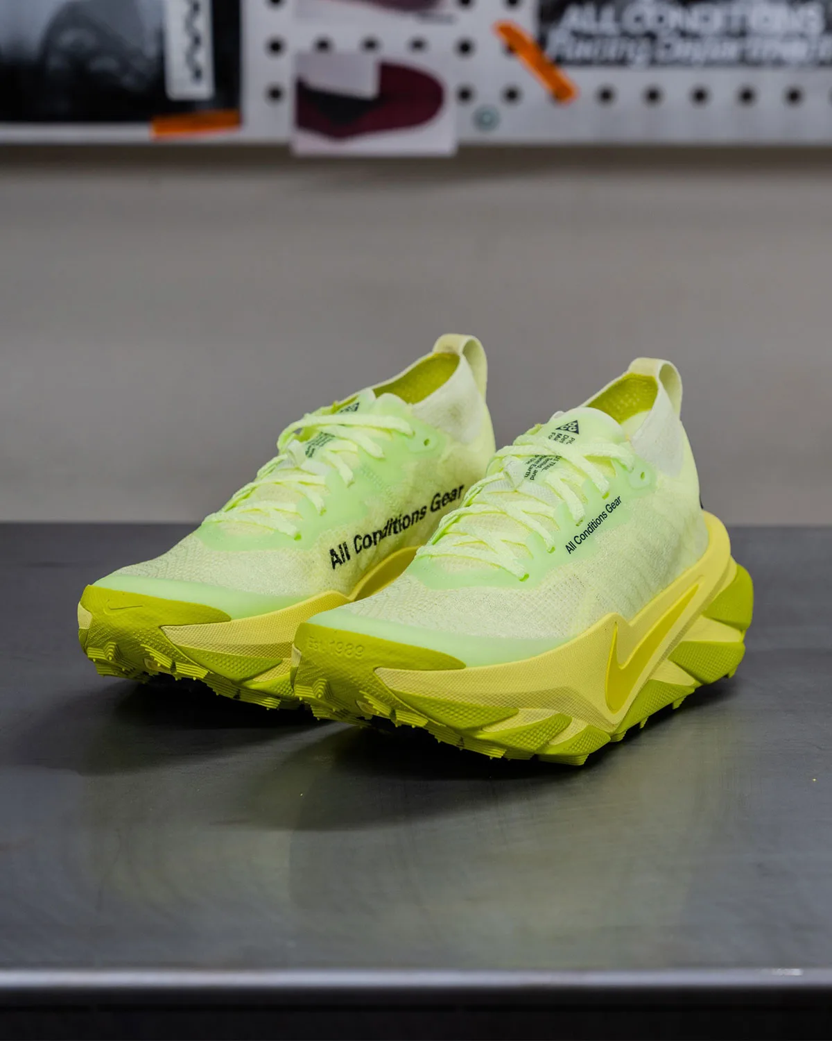 Front three-quarter pair on workshop table, pale green mesh and yellow outsoles, Nike ACG Picklejus