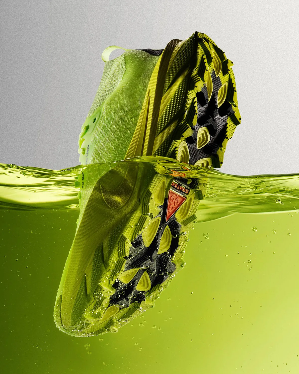 Toe dipped in green liquid, outsole showing orange ACG triangle and black lugs, Nike ACG Picklejus