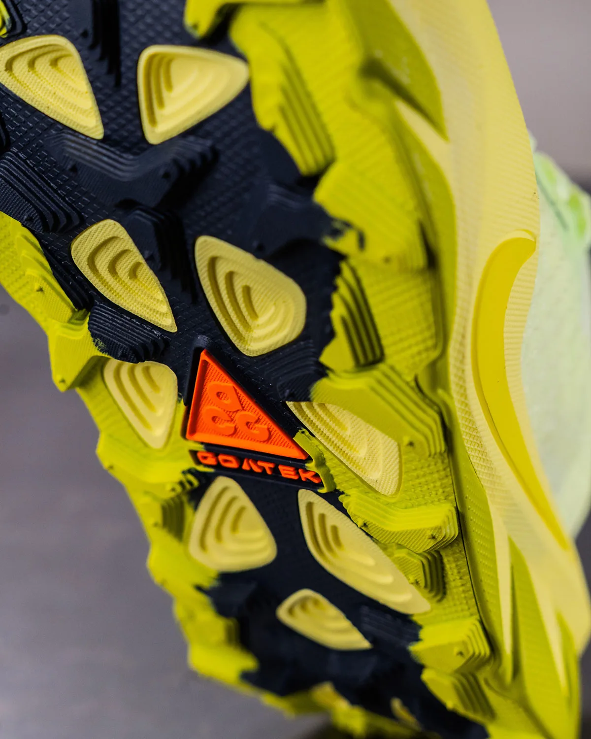 Macro of outsole tread with orange ACG triangle logo and Goatek text, Nike ACG Picklejus