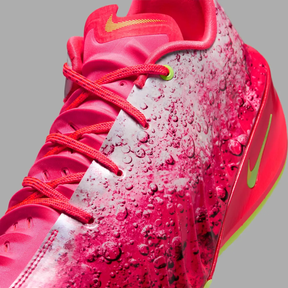 Close-up of the cherry-soda graphic, red laces, and lime Swoosh on the Paige Bueckers GT Cut 4