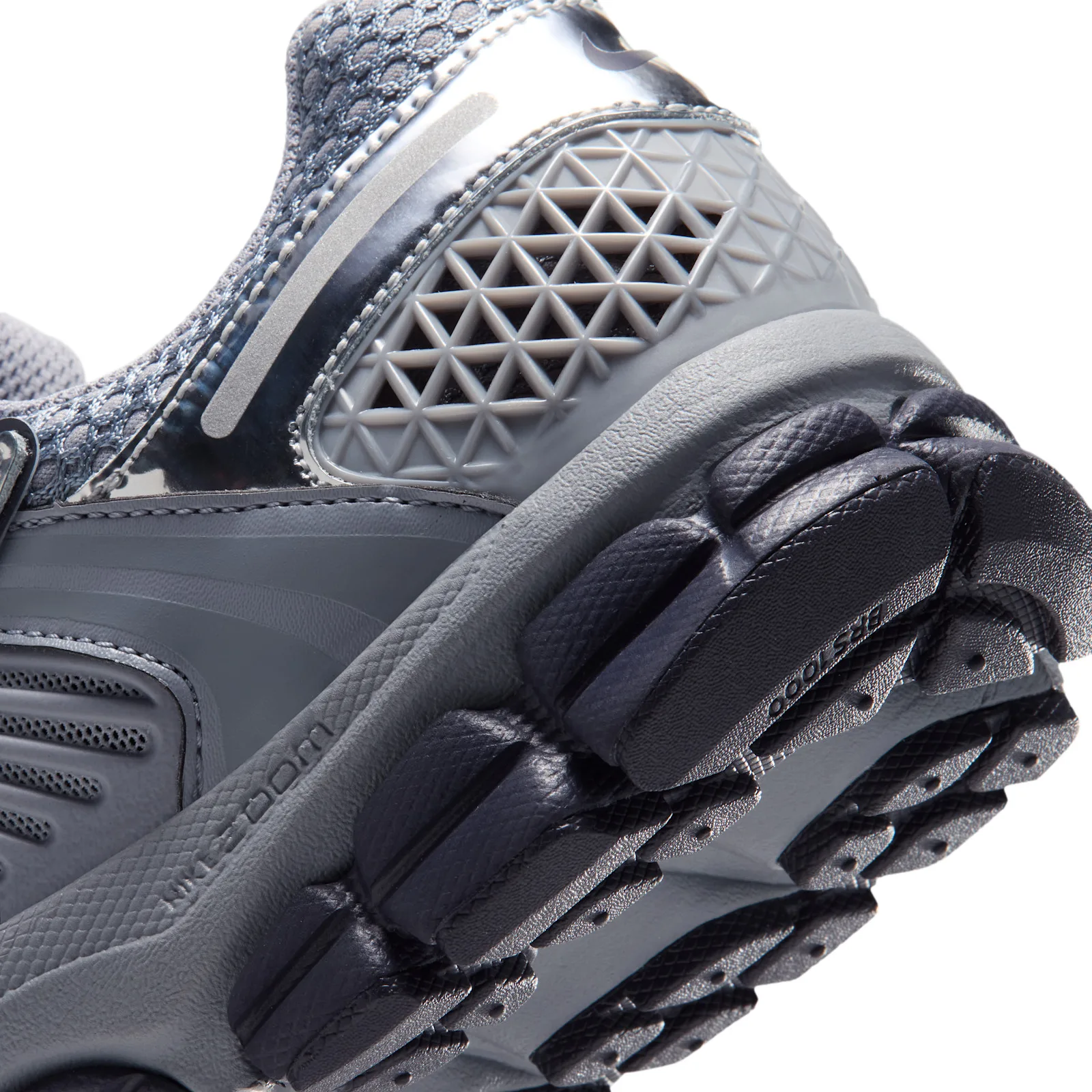 close-up heel and outsole detail, dark navy lugs with Bridgestone text, Gridiron