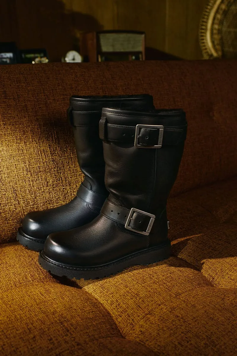 lateral pair, black leather buckle boots on a textured couch, Willy Chavarria Collection