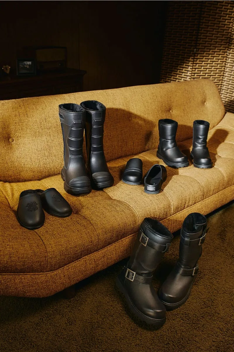 group of four styles - tall boots, ankle boots, mules and slippers on a couch, Willy Chavarria Collection