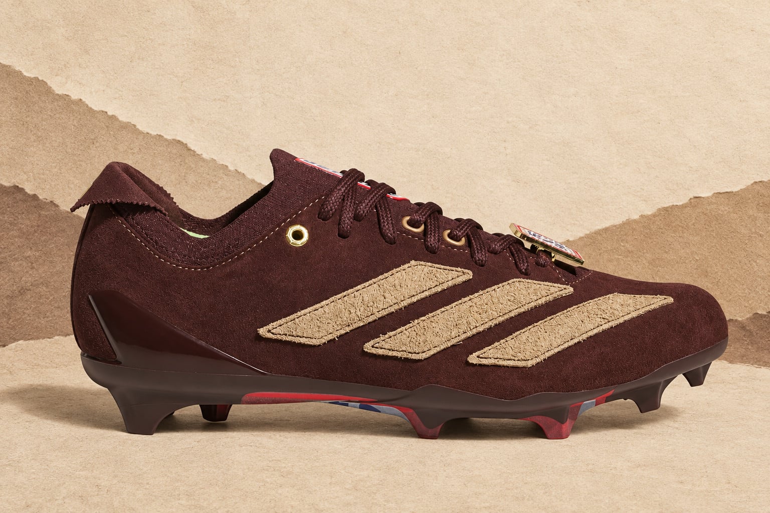 lateral view against torn paper backdrop, maroon suede with tan stripes, II x Snickers