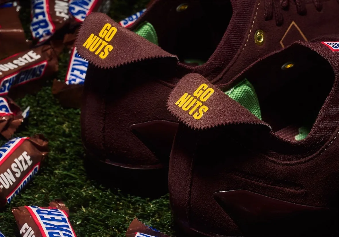 close-up heel tabs reading 'Go Nuts' in yellow, Snickers wrappers on turf, II x Snickers