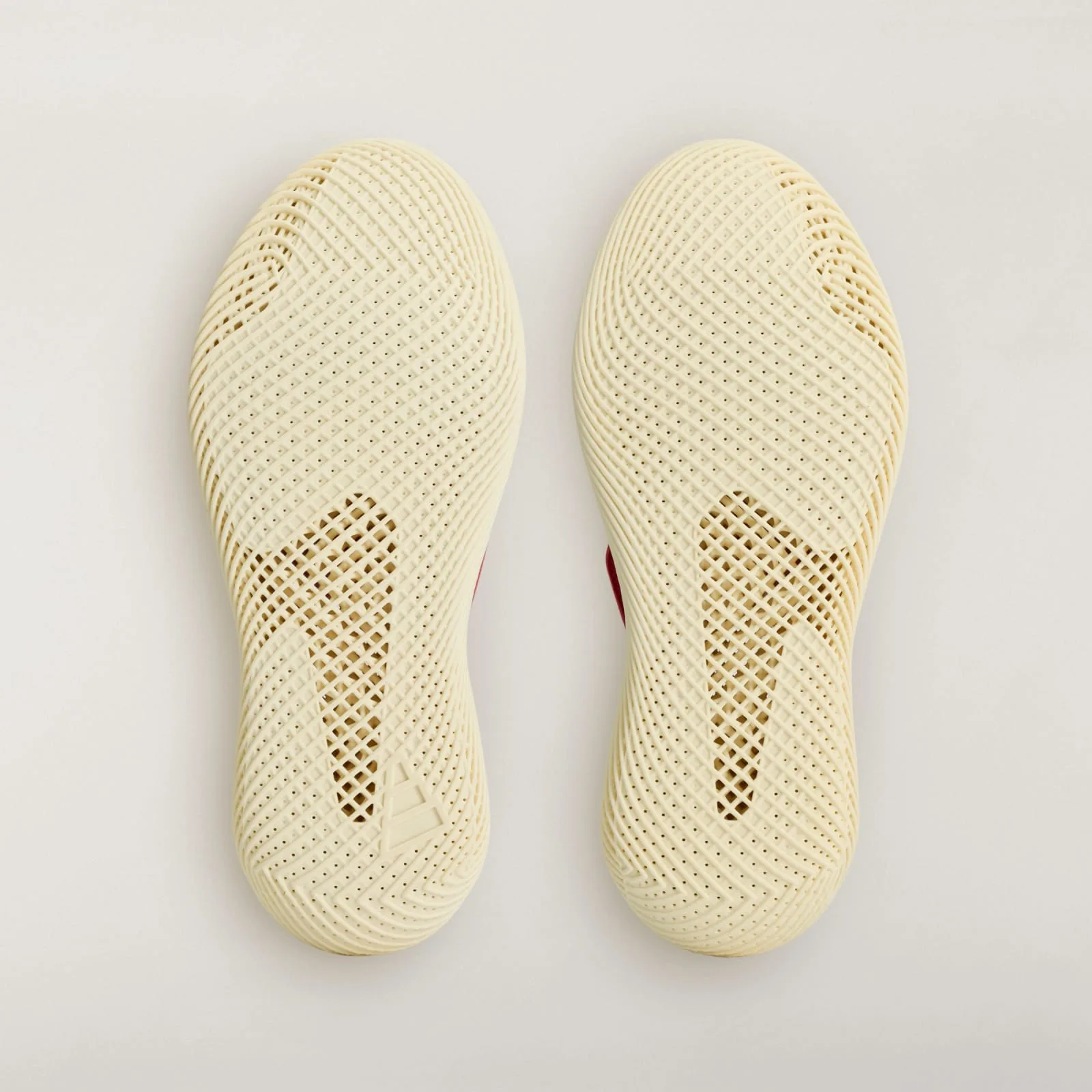 outsole view of pair, cream ridged rubber soles with embossed adidas logo, Collegiate Red