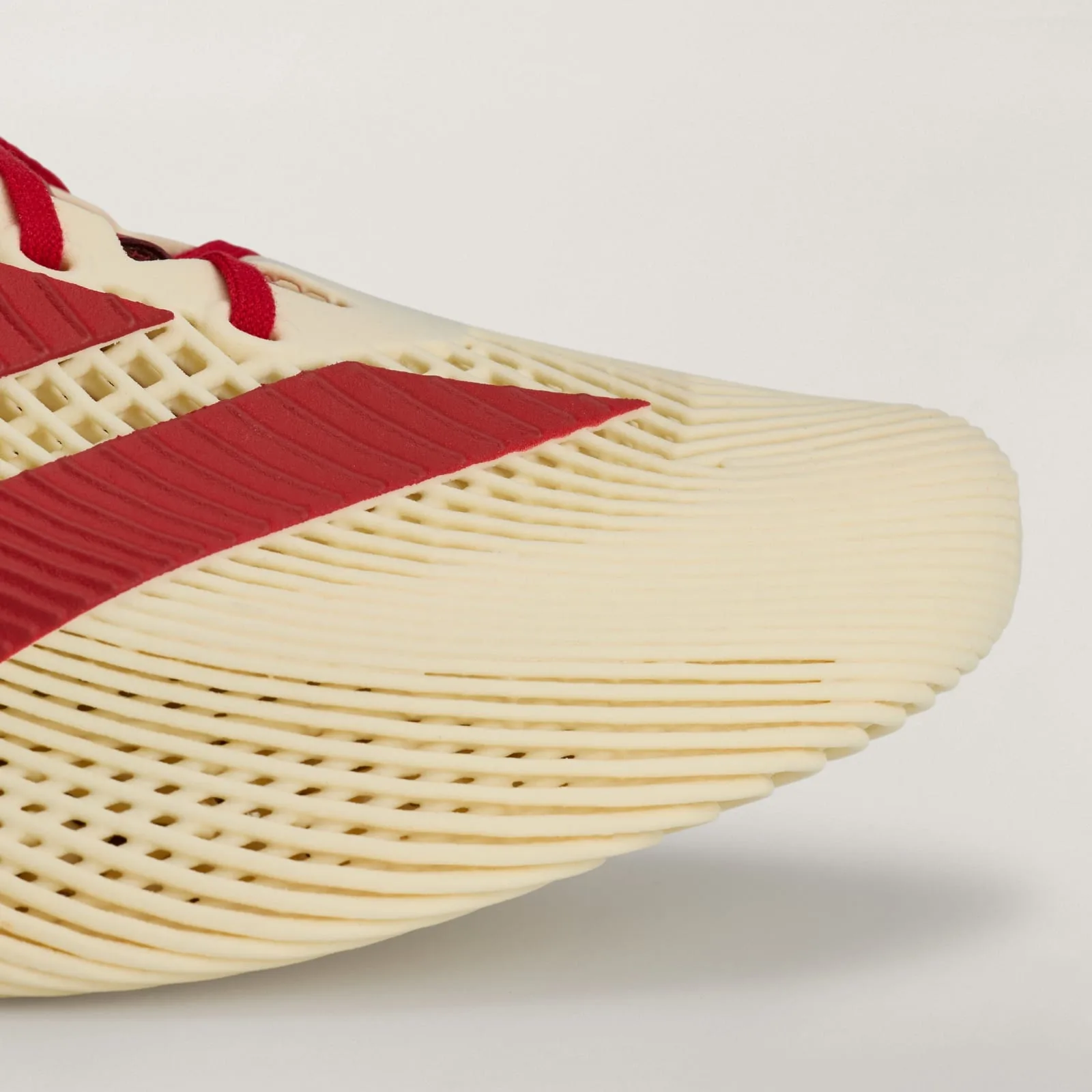 close-up of ribbed cream mesh toe box with red diagonal stripe overlay, Collegiate Red