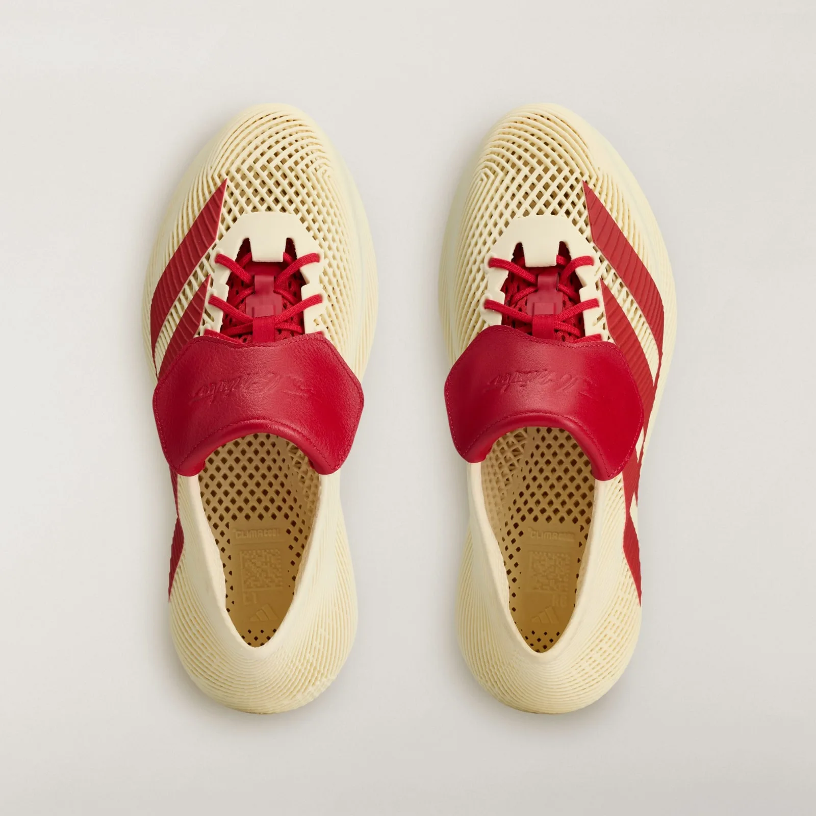 top-down pair, cream mesh, red laces and tongue tabs with embossed signature, Collegiate Red