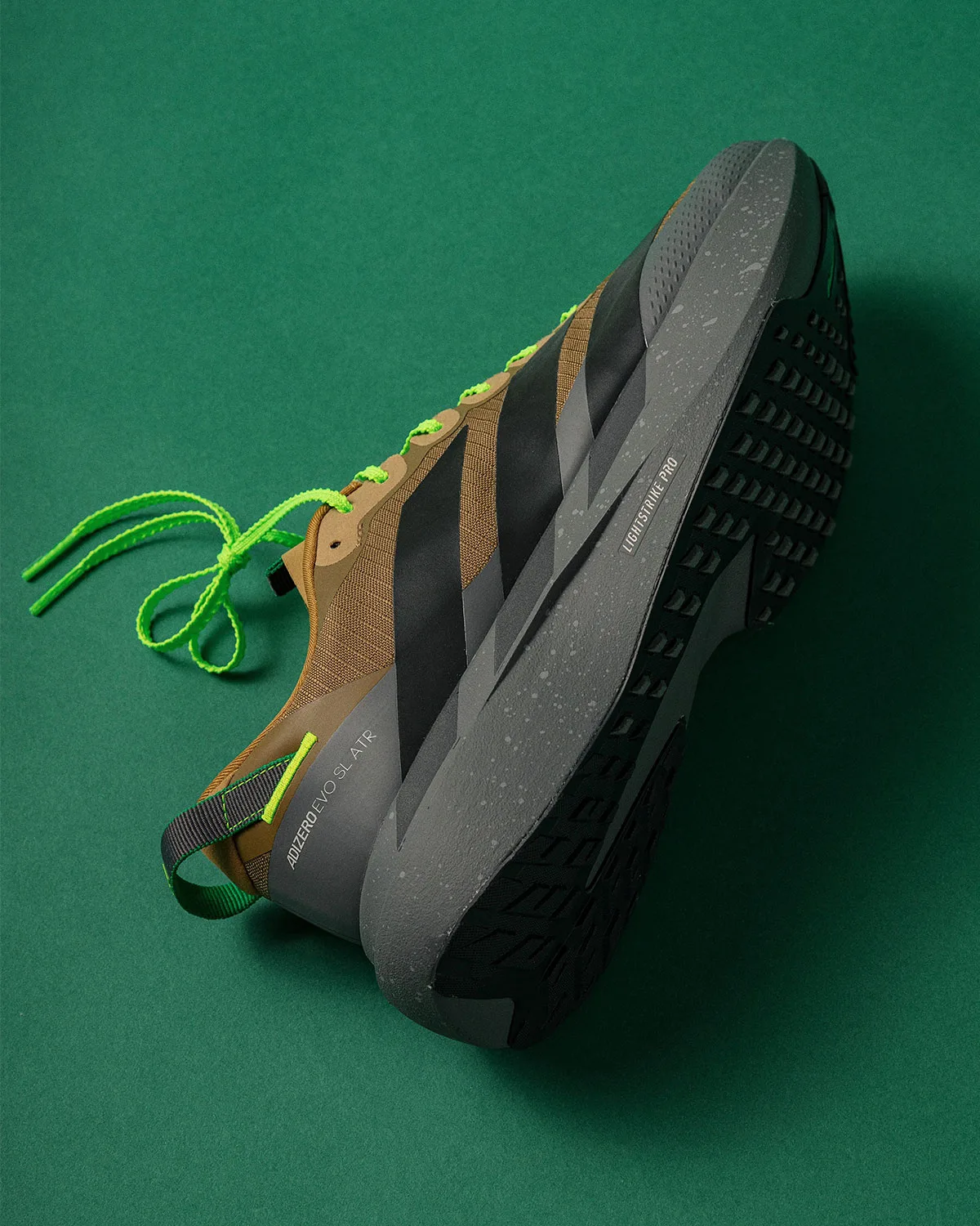 lateral side in hand, brown-black striped upper, gray speckled midsole, x Up There