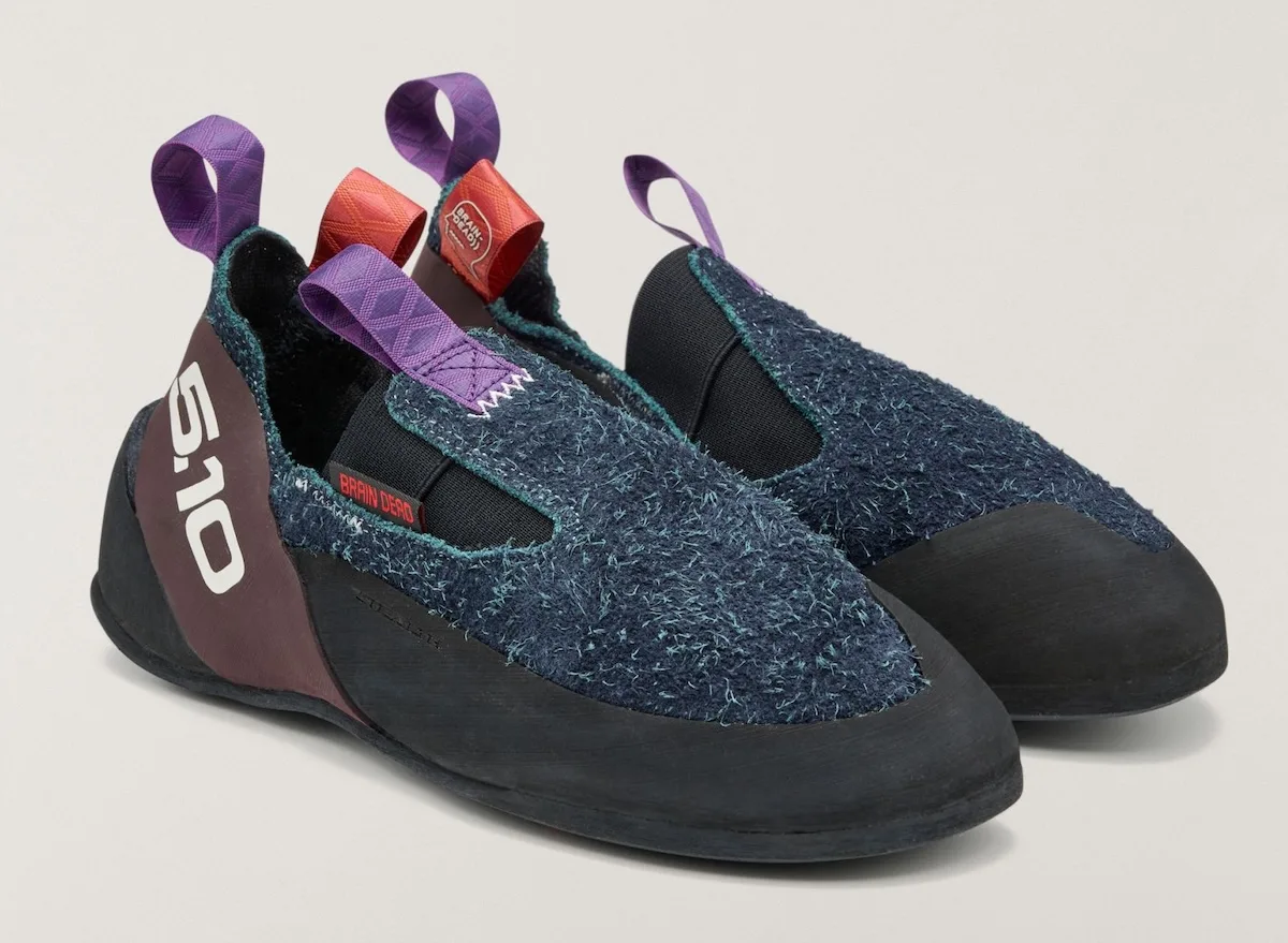 pair of navy slip-on shoes angled to show maroon heel and Brain Dead tab, Approach and Niad