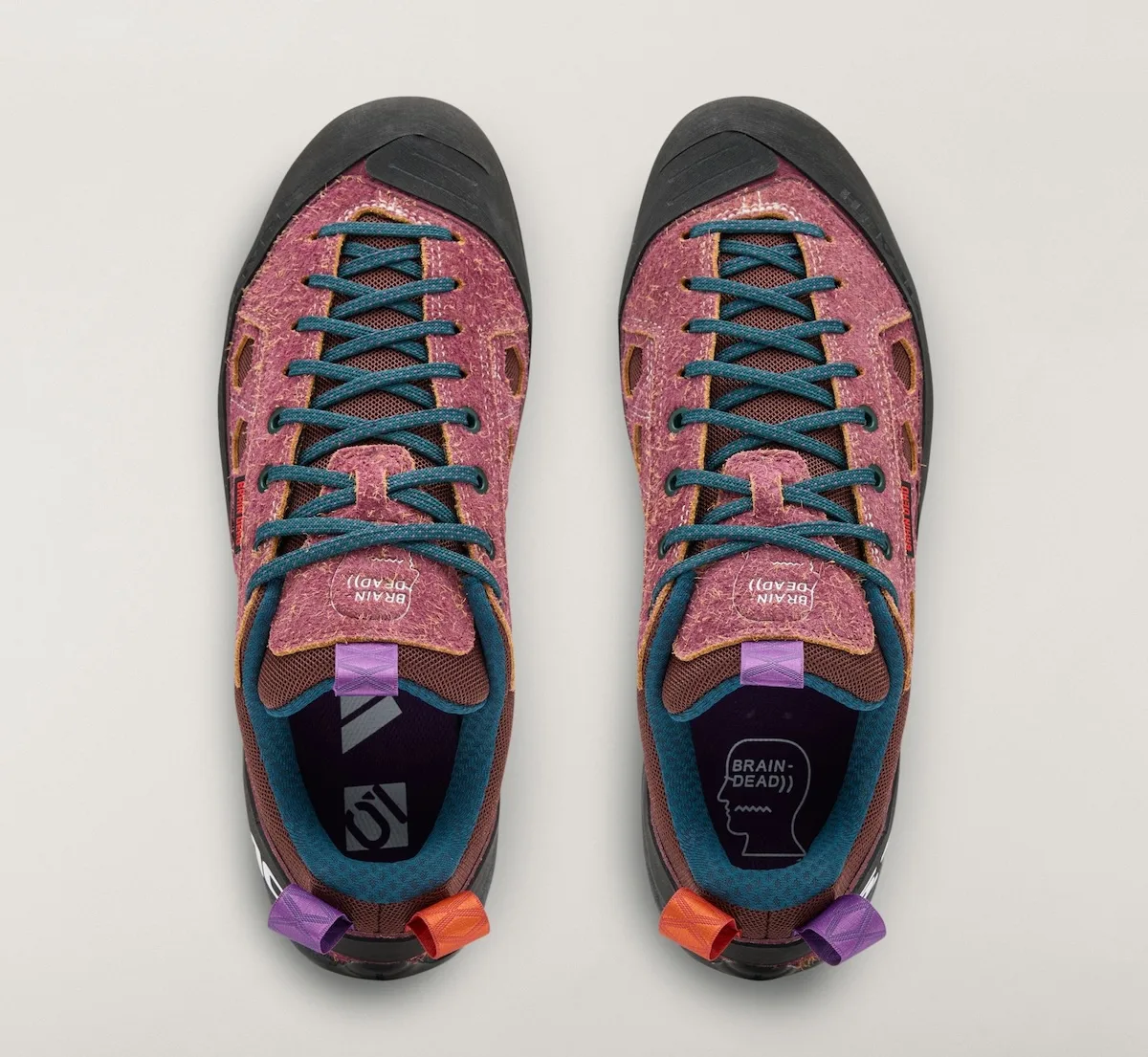 top-down view of mauve approach shoe pair with teal laces and Brain Dead tongue text, Approach and Niad