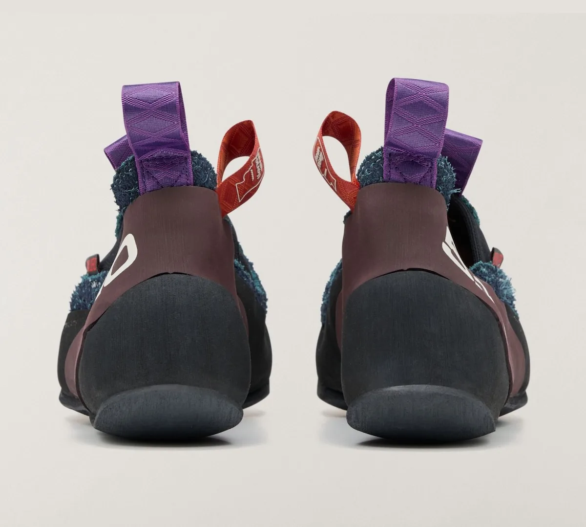 heel view of navy slip-on pair showing purple and red pull loops, Approach and Niad