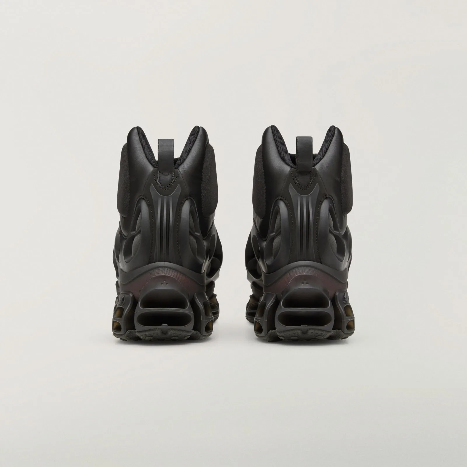 heel view of pair, ribbed leather counters with pull loops, vented cage sole, Wolf