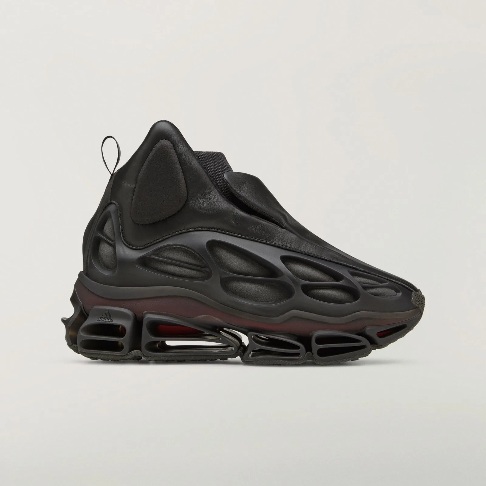 lateral view, black leather upper over molded cage sole with red midsole strip, Wolf