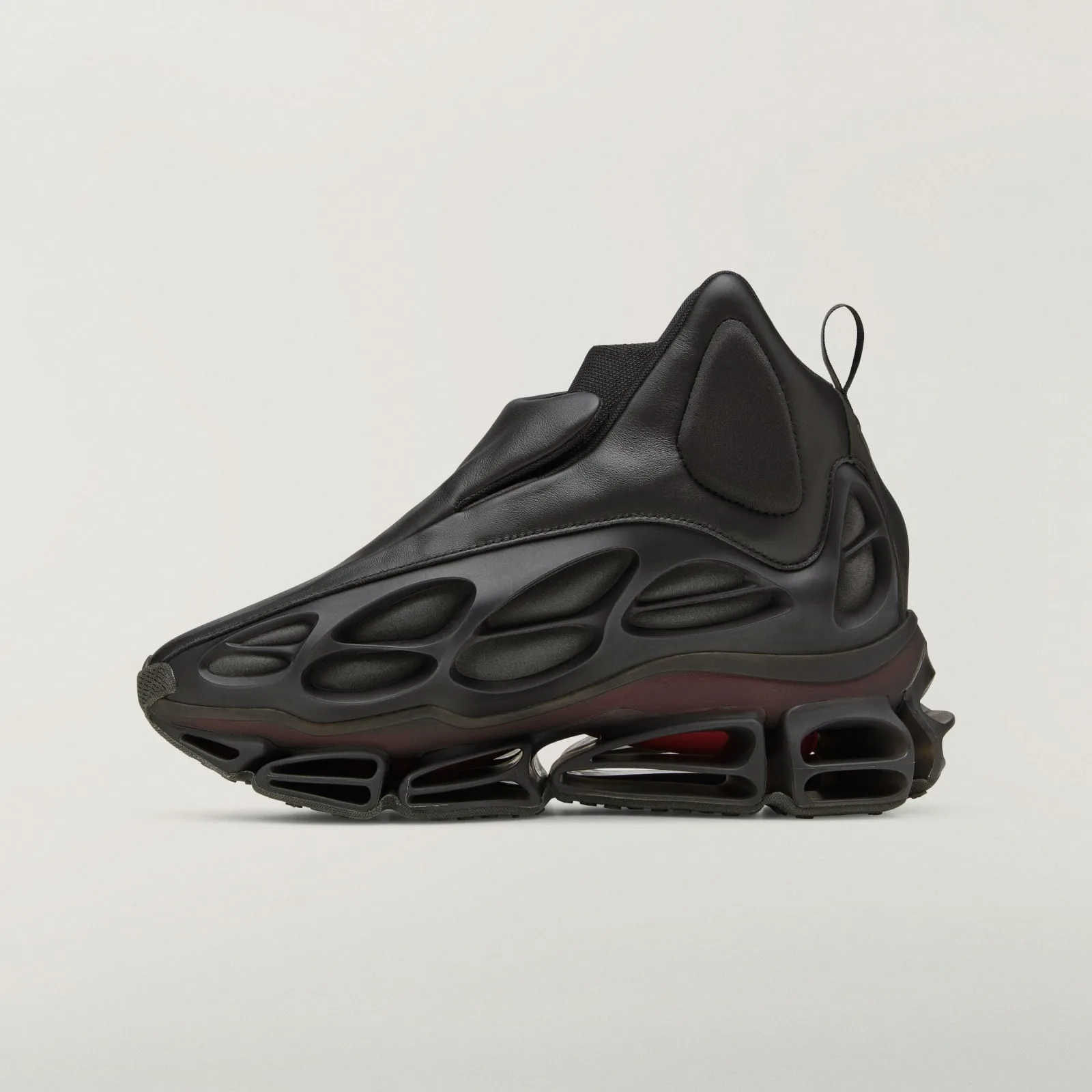 medial view, black leather upper with pull loop at heel, cage-sole detailing, Wolf