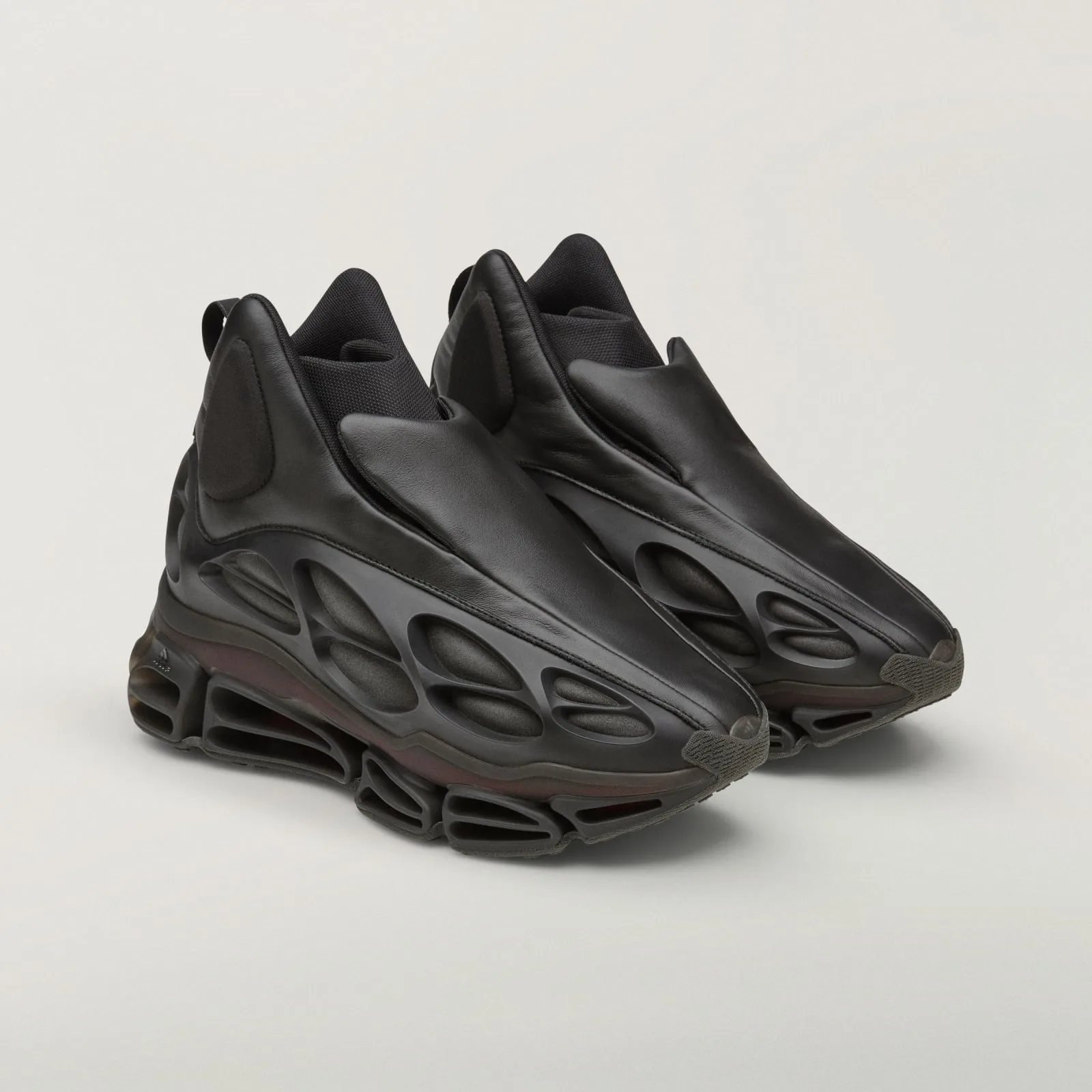 angled front view of pair, black leather toe boxes with cage-sole venting, Wolf