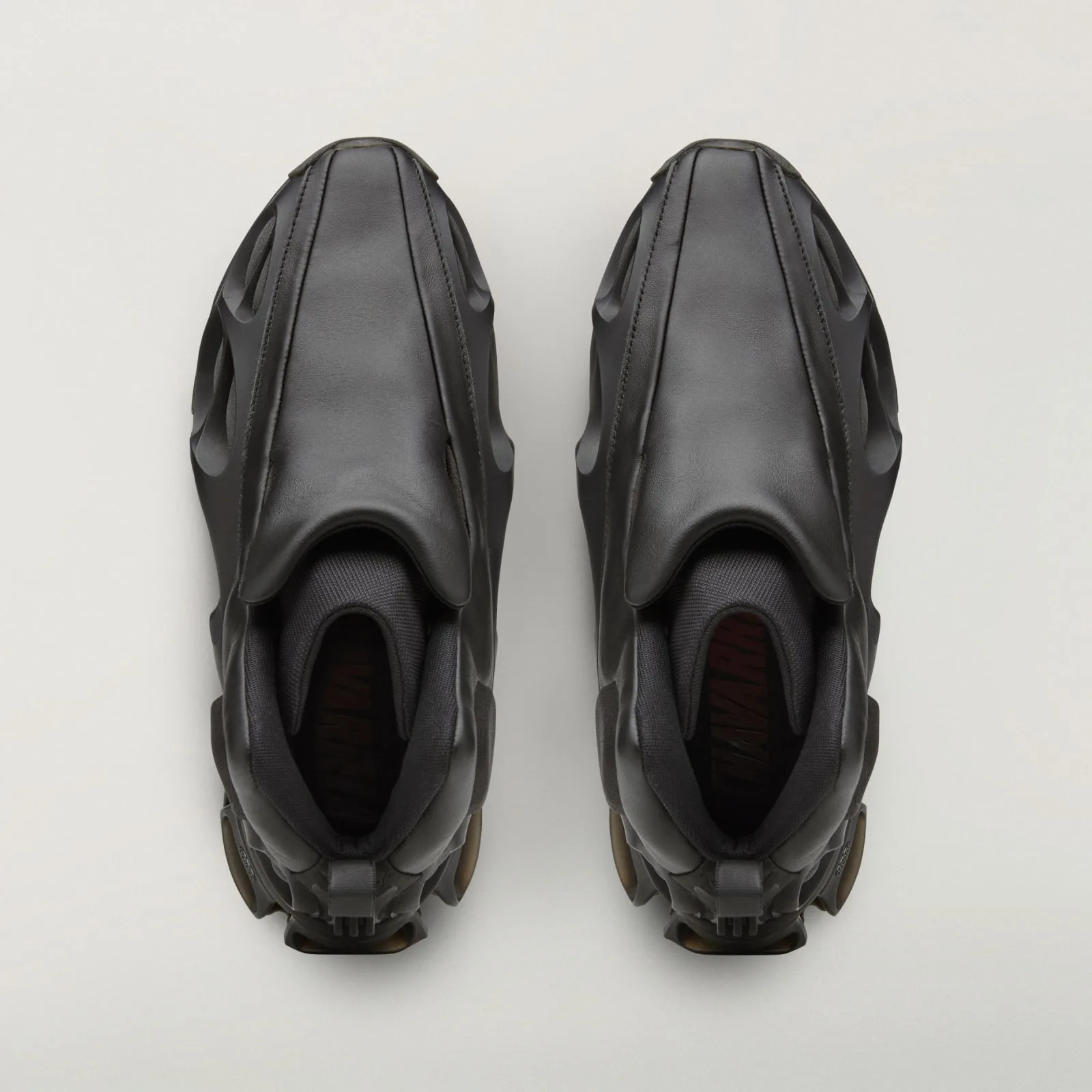 top-down view of pair, black leather quarters, red text on mesh tongue lining, Wolf