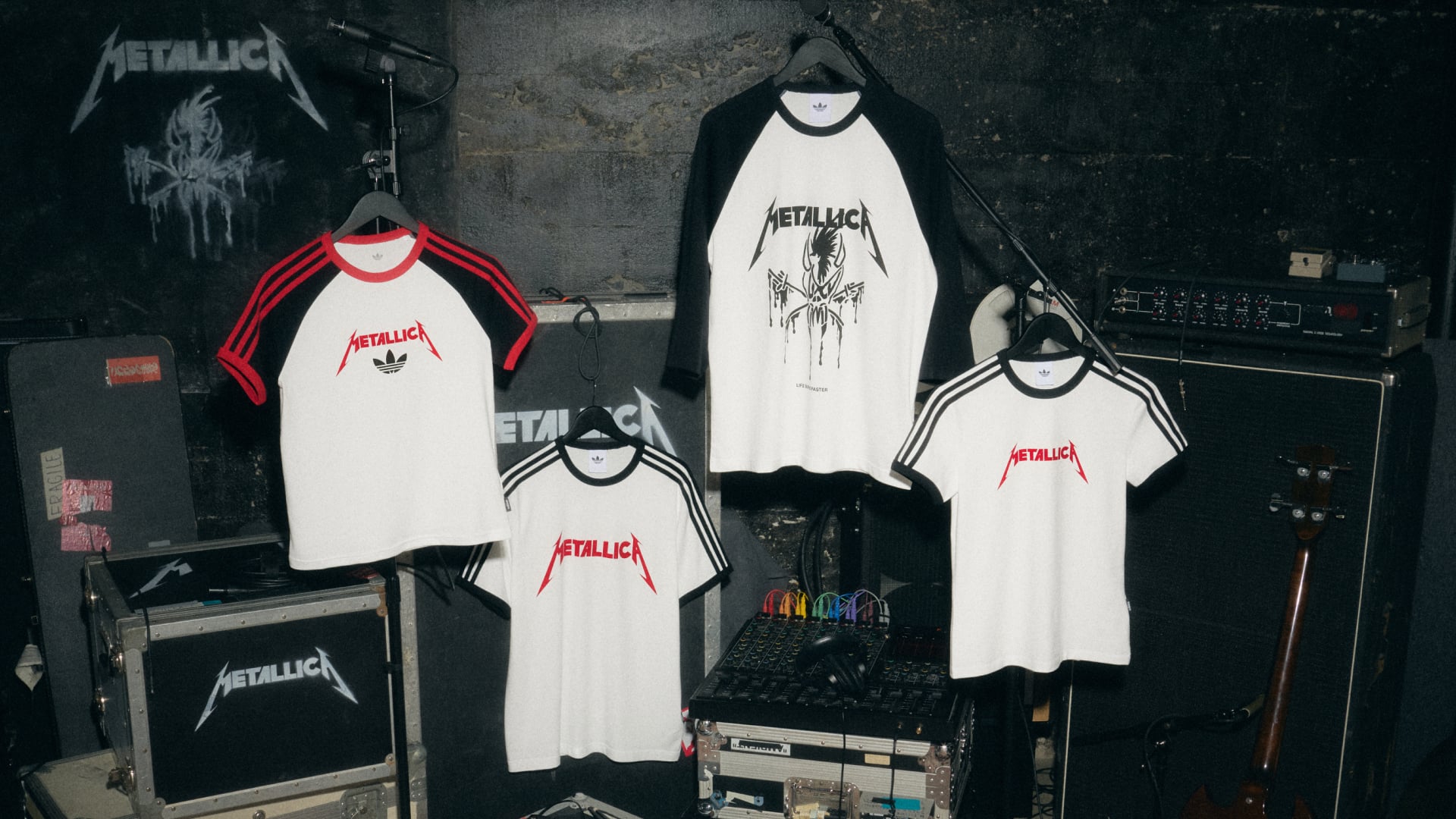 four hanging tees, black long sleeve with spider graphic, red-striped raglan tee, Life Burns Faster