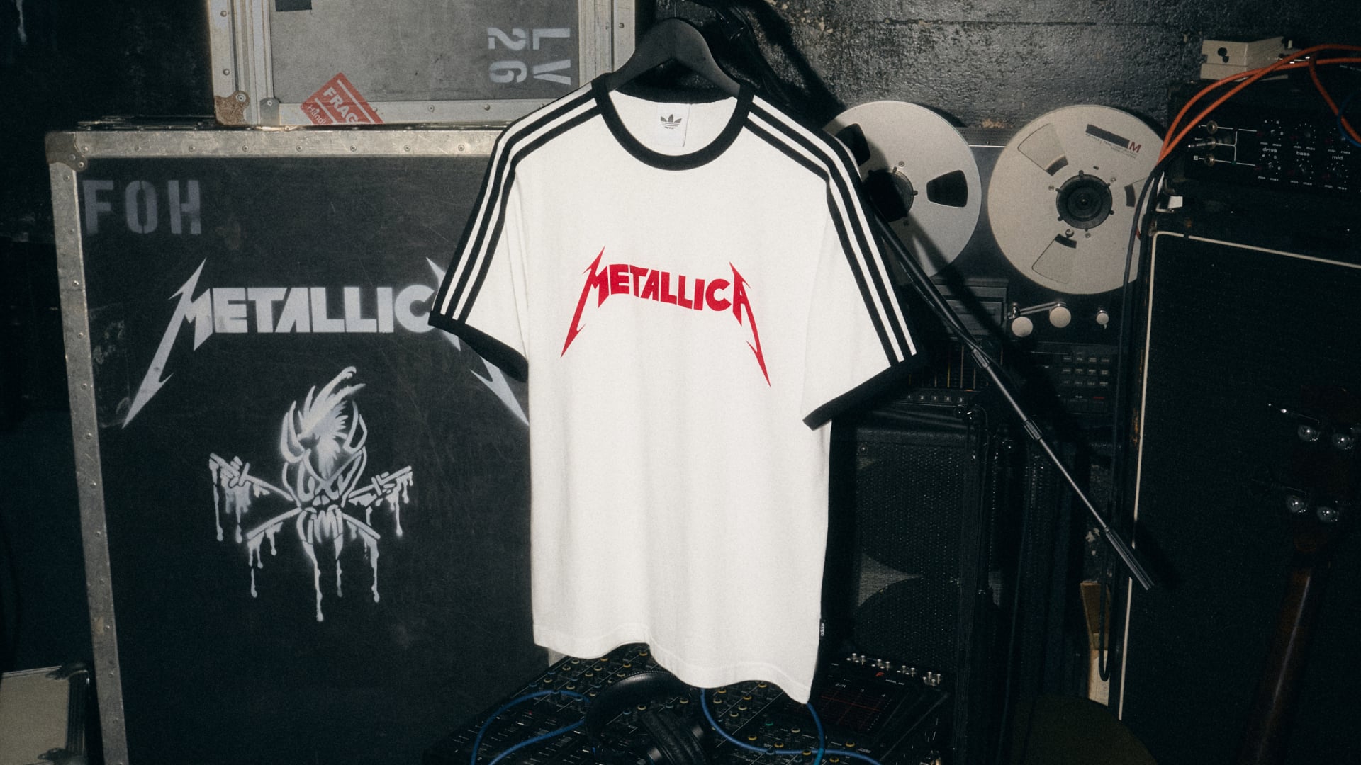 white tee with red Metallica logo, black stripes, mic stand crossing front, Life Burns Faster
