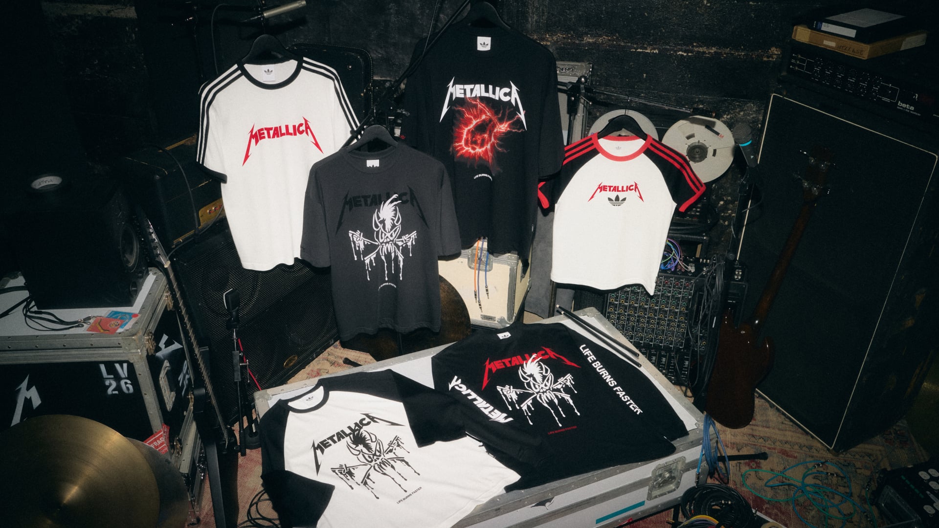 assorted tees: white ringer, black spider-graphic tee, red lightning burst design, Life Burns Faster