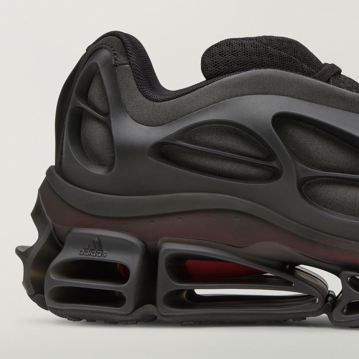 close-up of heel and midsole, maroon-tinted panel, adidas wordmark on cage, Willy Mega Mid)