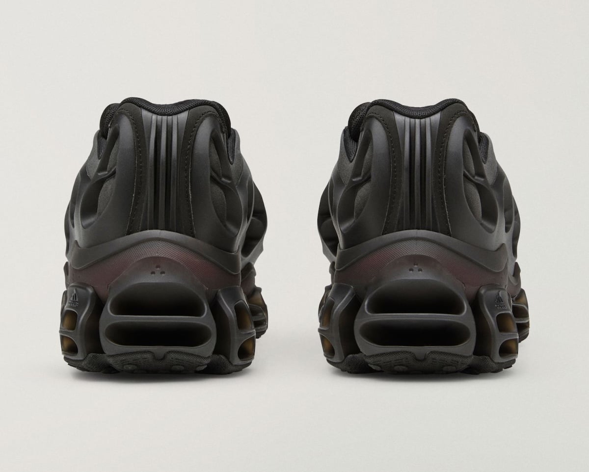 heel view of black low-top pair with maroon-tinted midsole strip, Willy Mega Mid)