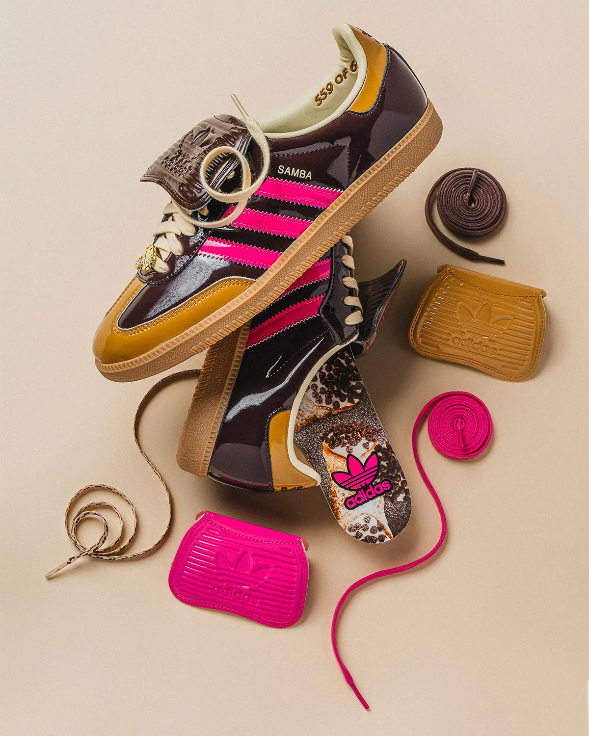 pair stacked with lace jewel charm, loose pink and tan laces and mudguards beside them, Cannoli