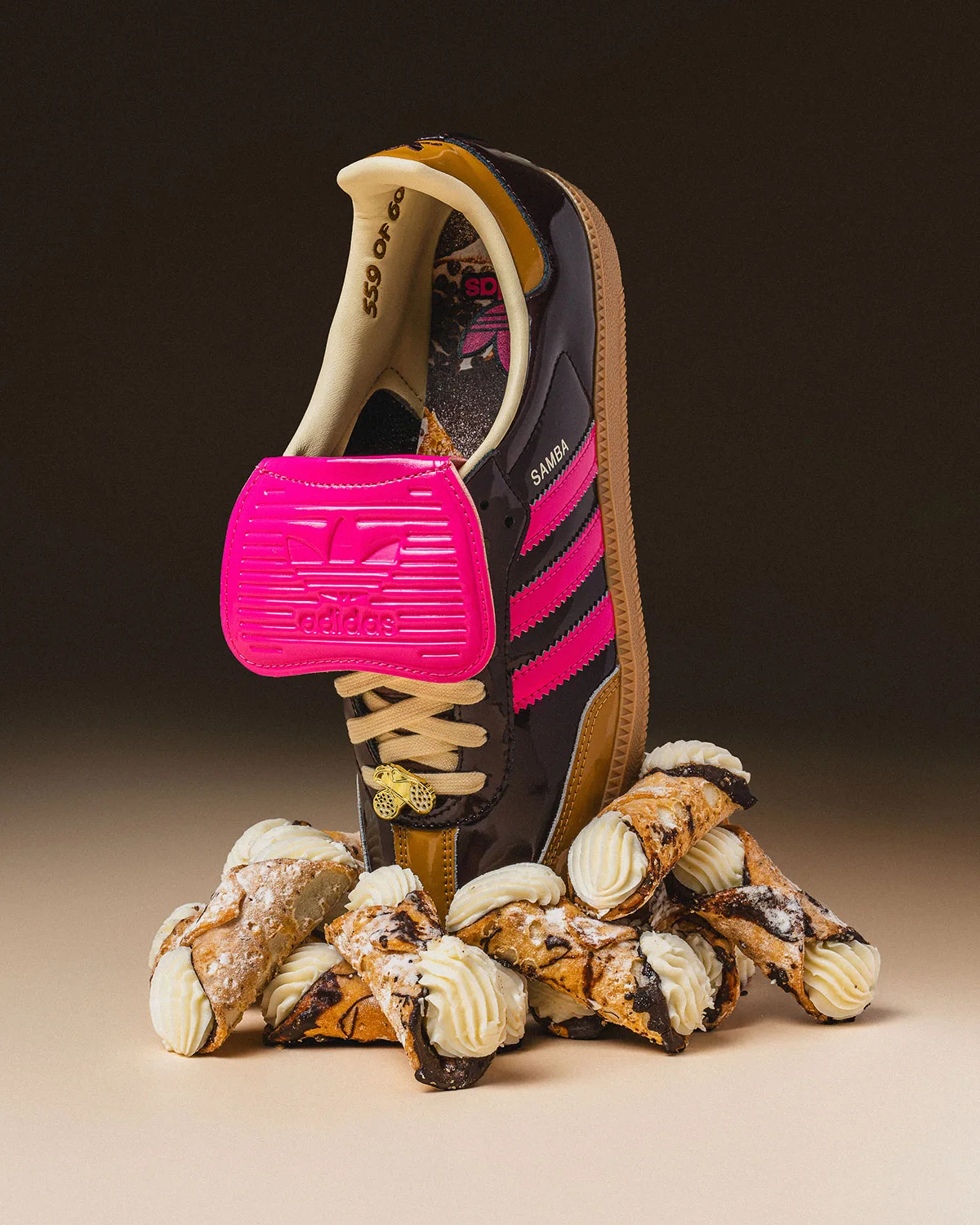 single shoe upright with pink adidas mudguard flap down, propped in cannoli pastries, Cannoli