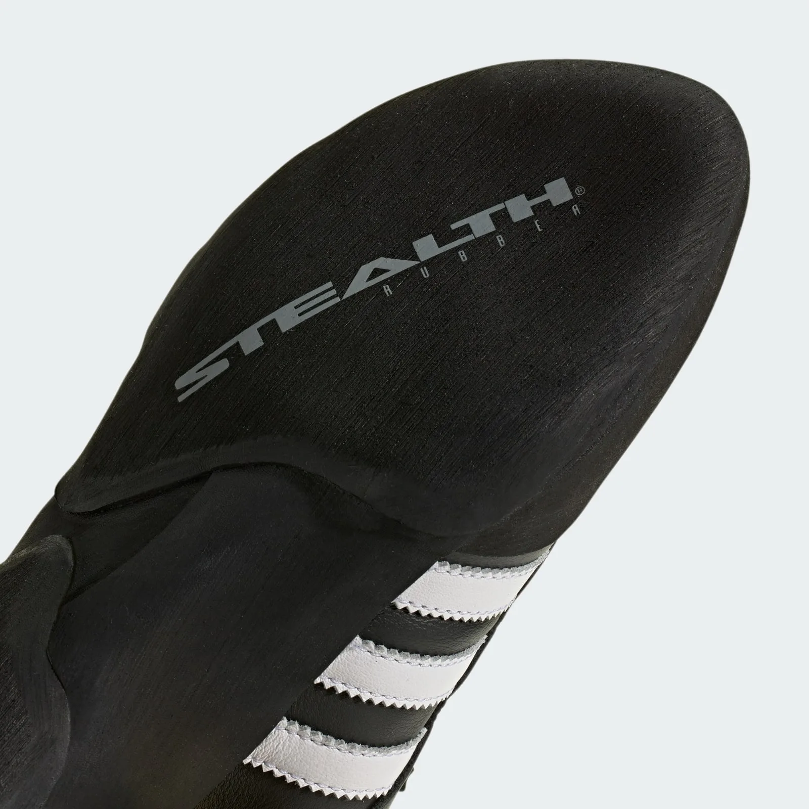 close-up outsole detail, stealth rubber text embossed above white stripes, Samba Climbing Shoe