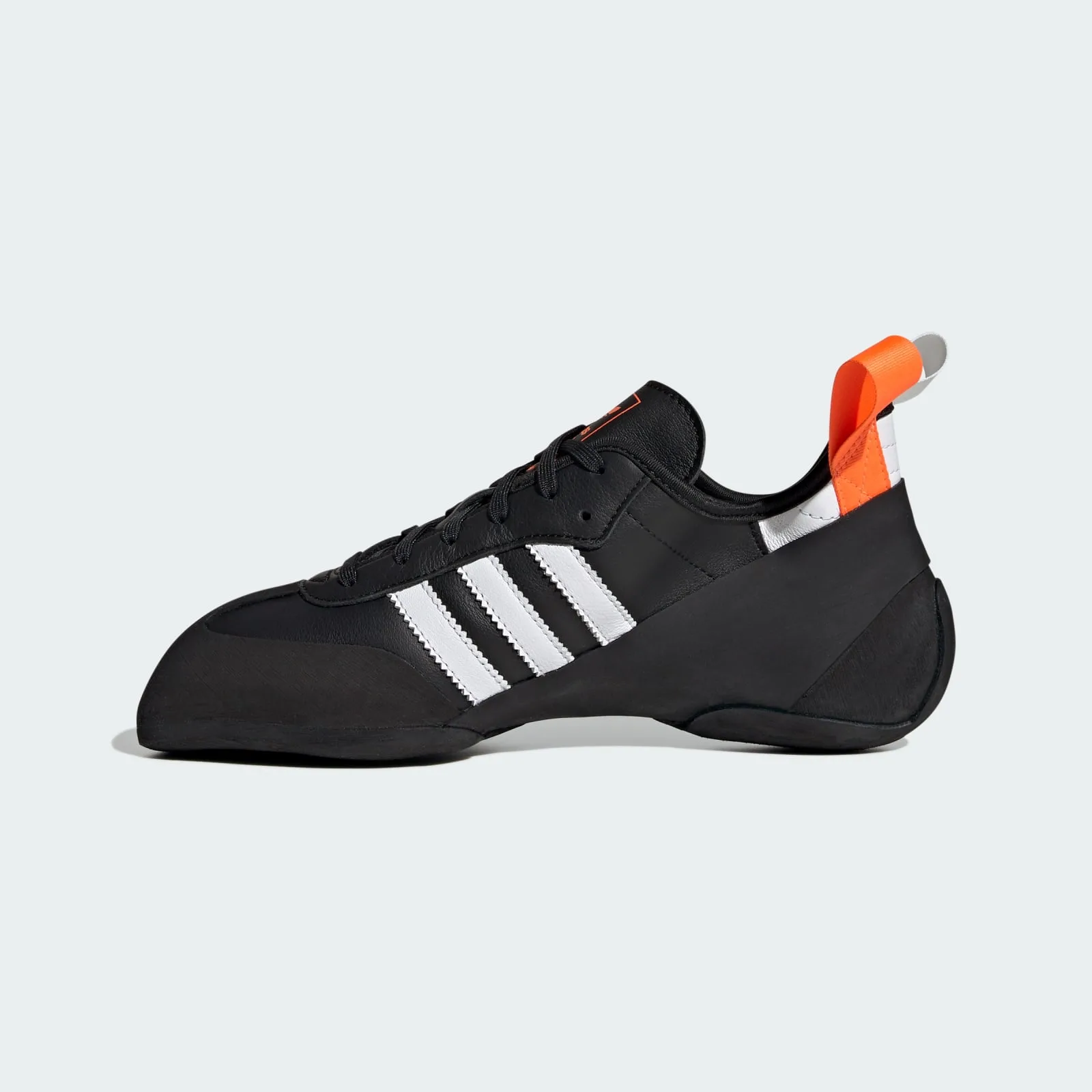 close lateral view of toe, orange trefoil tongue logo and white pull tab, Samba Climbing Shoe