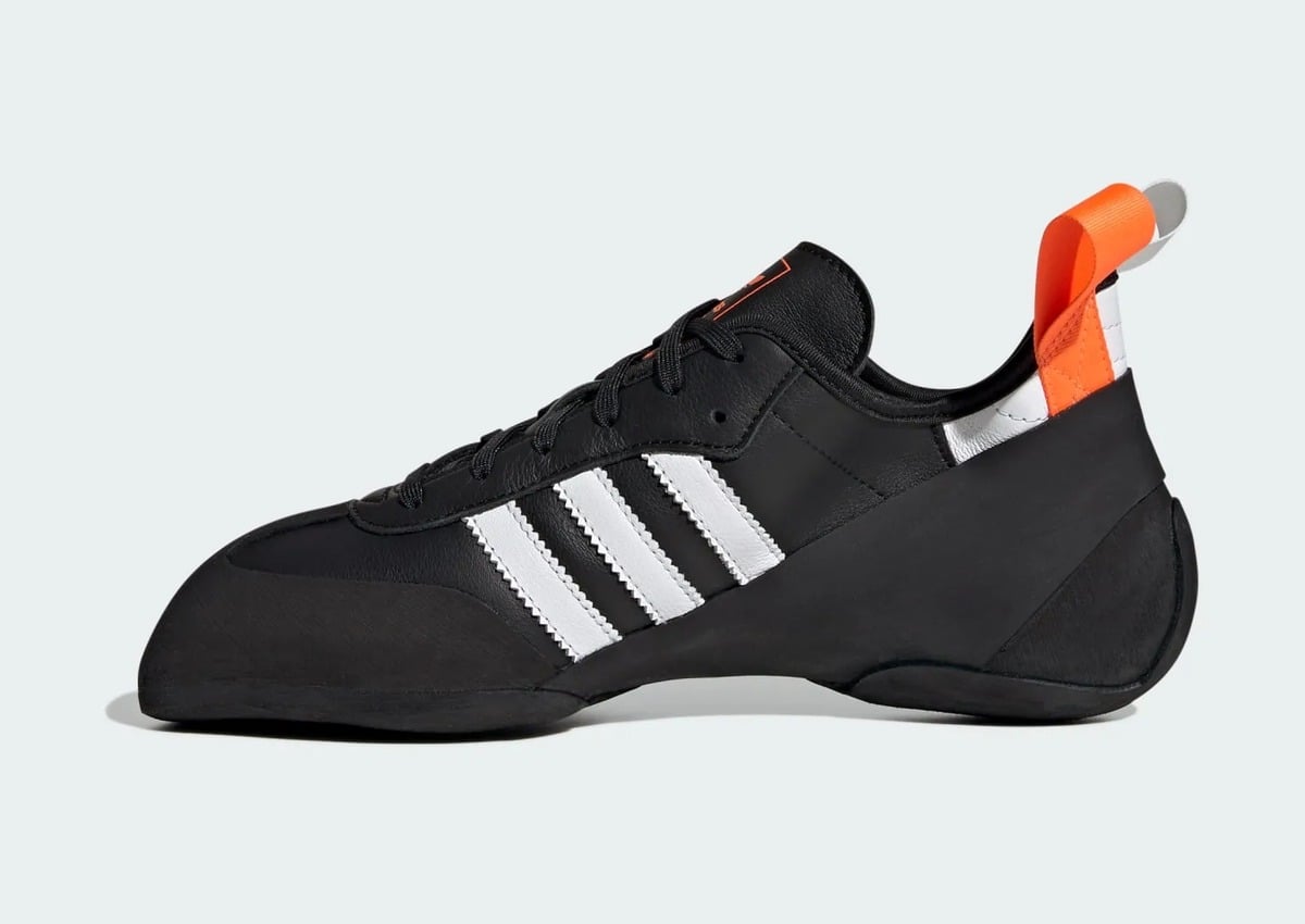 lateral view, black leather upper with white three stripes and orange pull tab, adidas Samba Climbing Shoe