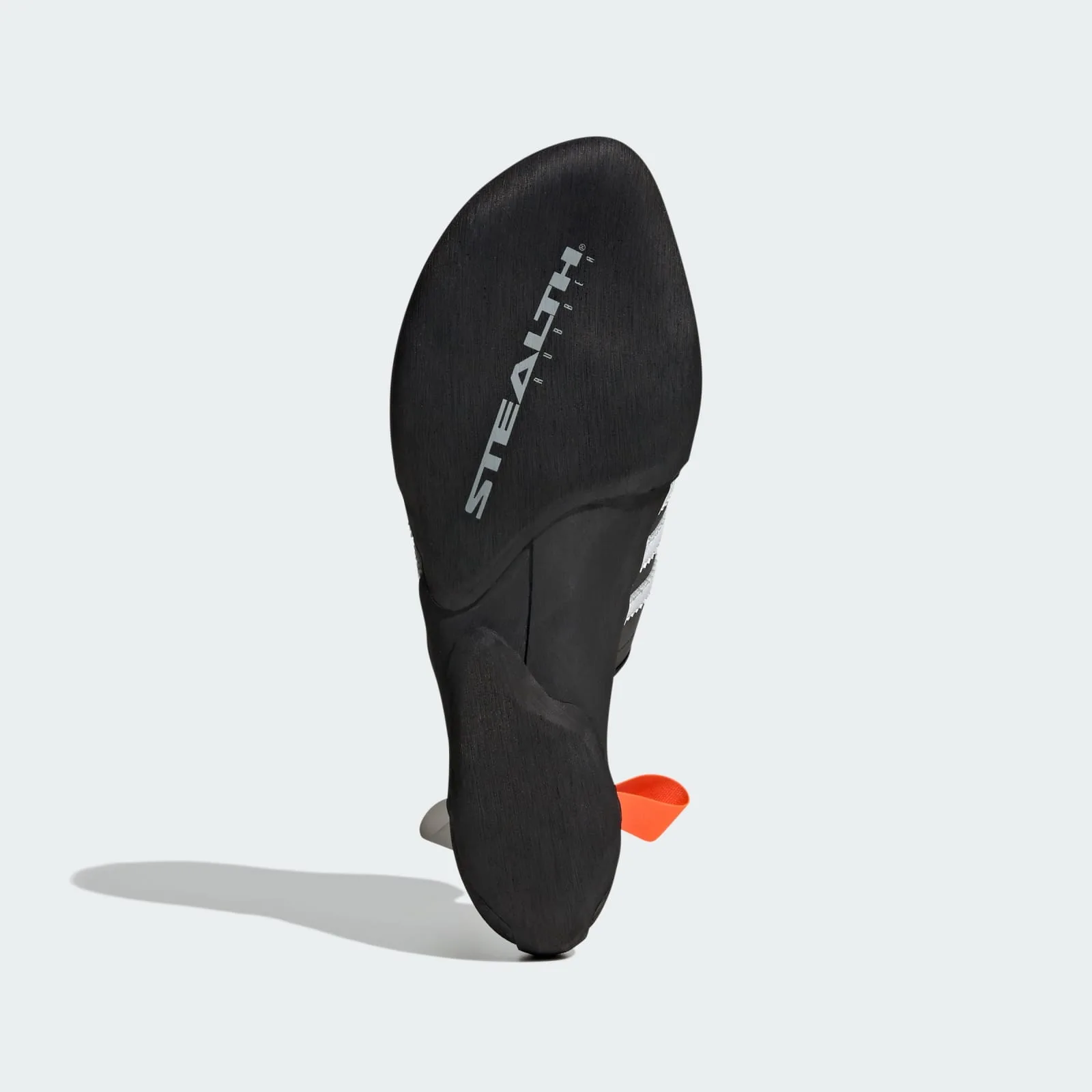 angled outsole view, black stealth rubber sole with orange tab peeking through, Samba Climbing Shoe