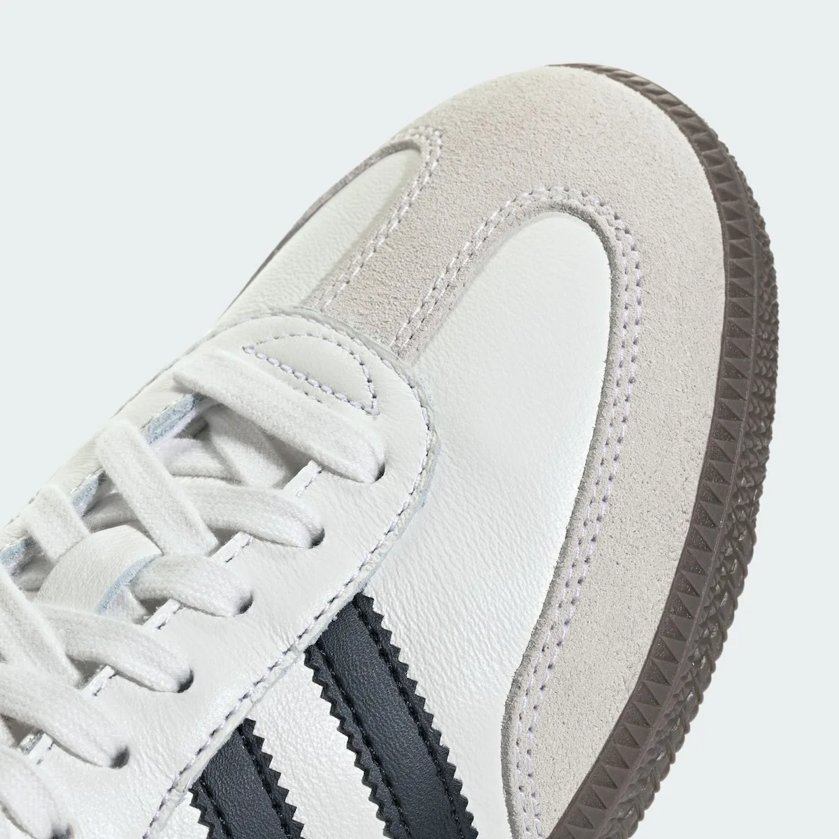 close-up detail of toe box stitching, suede overlay and gum sole edge, adidas Samba Mule