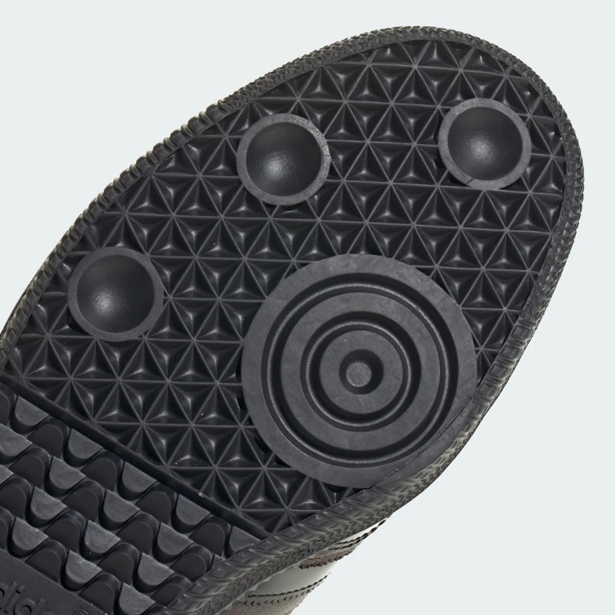 close-up of outsole, black tread with concentric heel pods, x TTT MSW