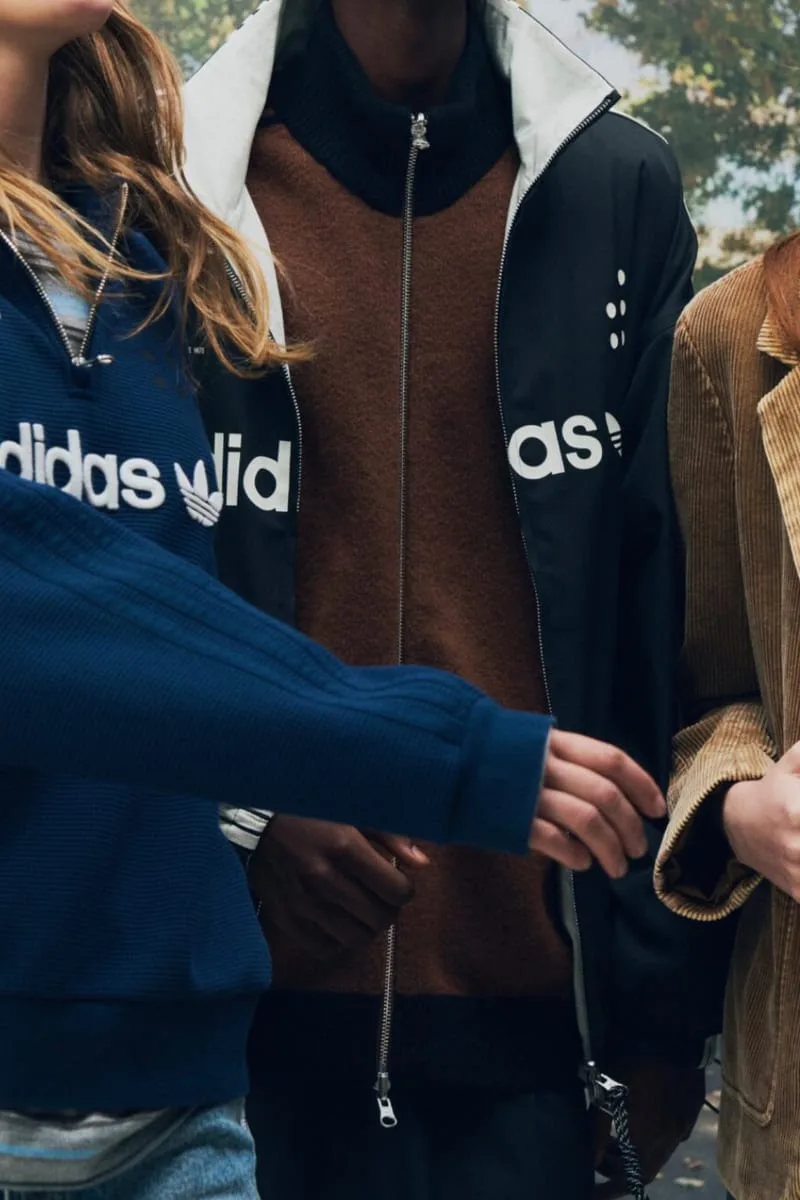 cropped group wearing navy, black and brown adidas jackets outdoors, PRO SFTM 011)