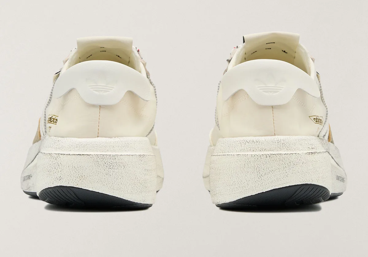 heel view of cream SL 72 Pro pair showing embossed trefoil heel tabs, SL 72 Pro)
