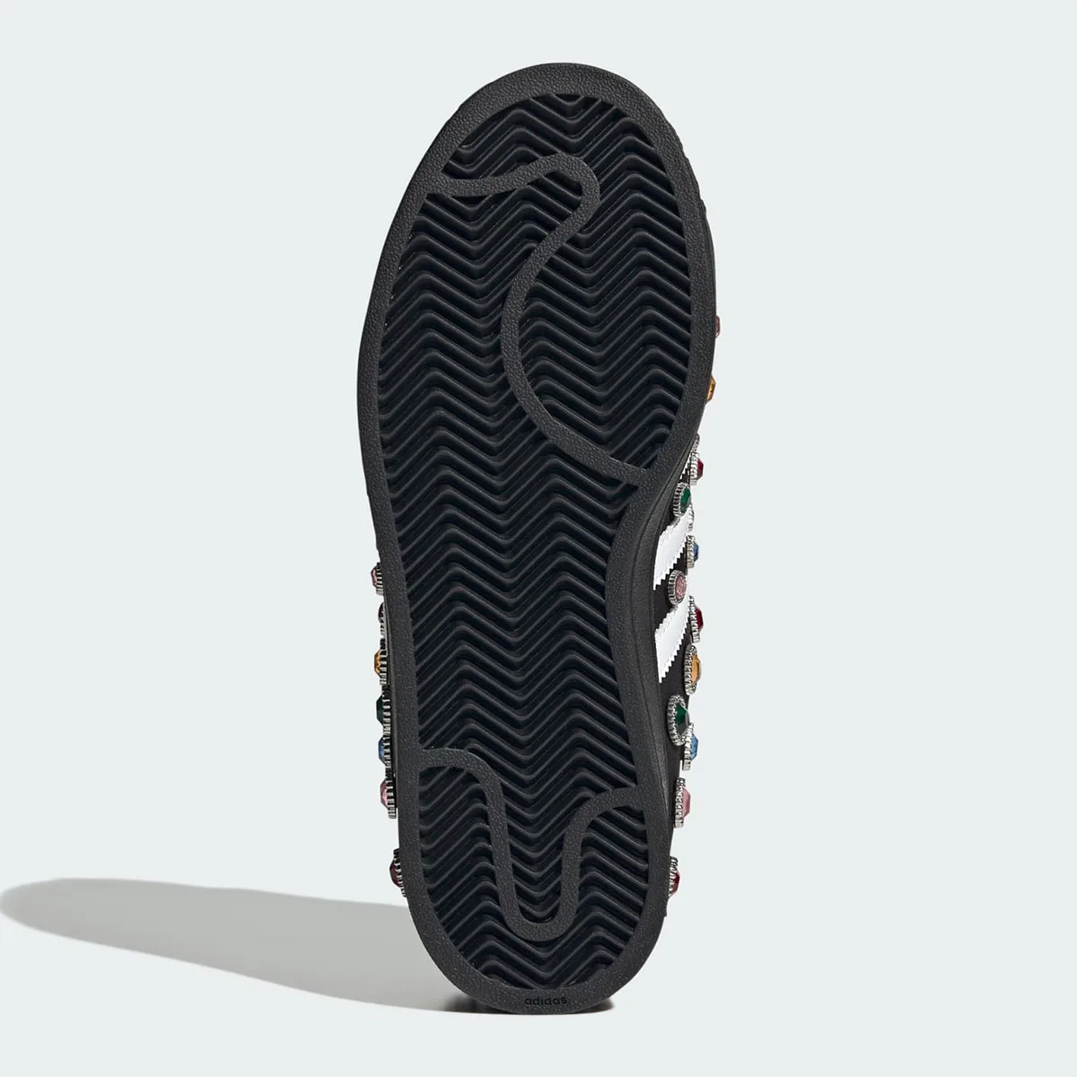 outsole view, black herringbone tread with jewels visible along the sidewall, Jewel