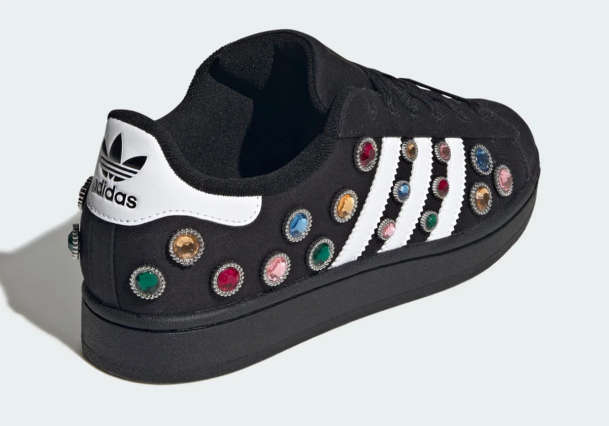 heel-angled view, white heel tab with black trefoil logo beside jewel studs, Jewel