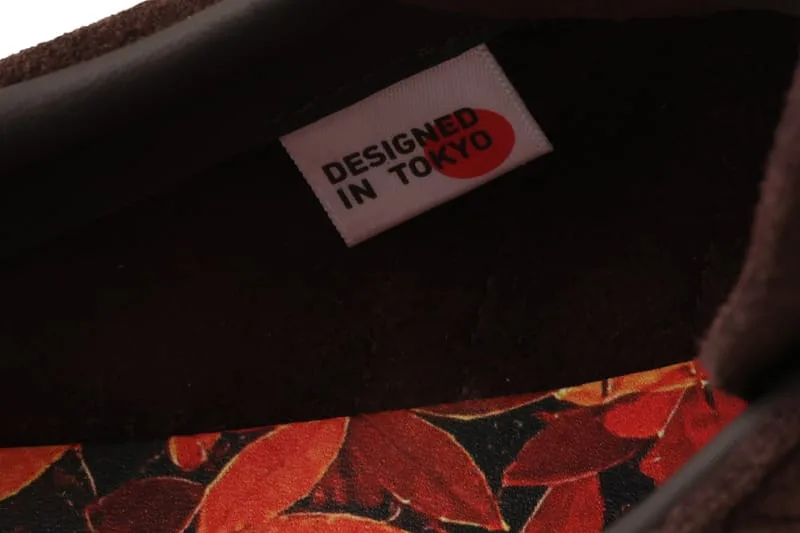 close-up detail, 'Designed in Tokyo' tag on orange floral lining, KOYO