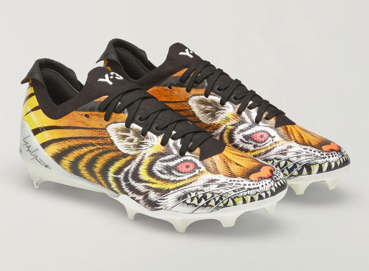 Pair, tiger graphic cleats angled toe-forward on white background, Beast