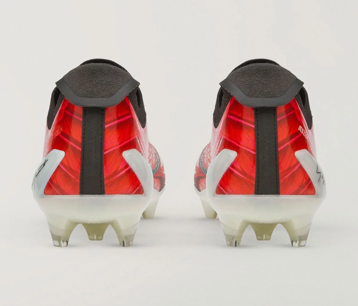 Heel view of the pair, red feather pattern with black pull tab and white studs, Beast