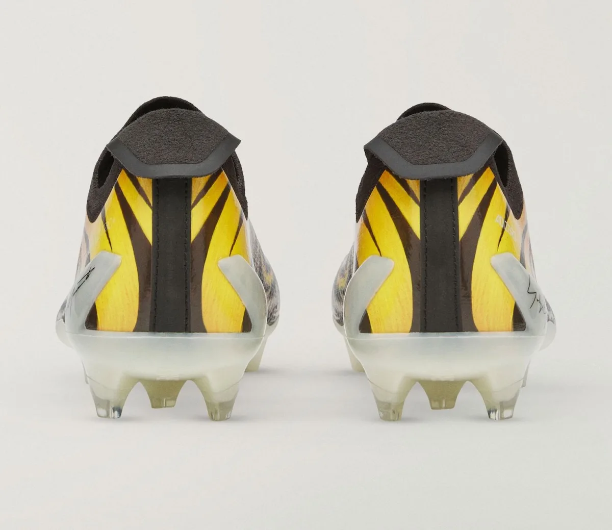 Heel view of the pair, yellow tiger-stripe pattern with black pull tab, Beast