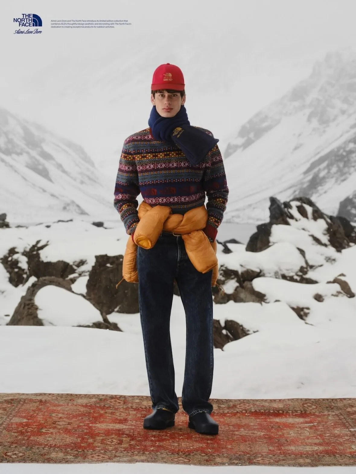 on-foot, fair isle sweater, red logo cap, mustard puffer tied at waist, Fall/Winter 2026 Collection