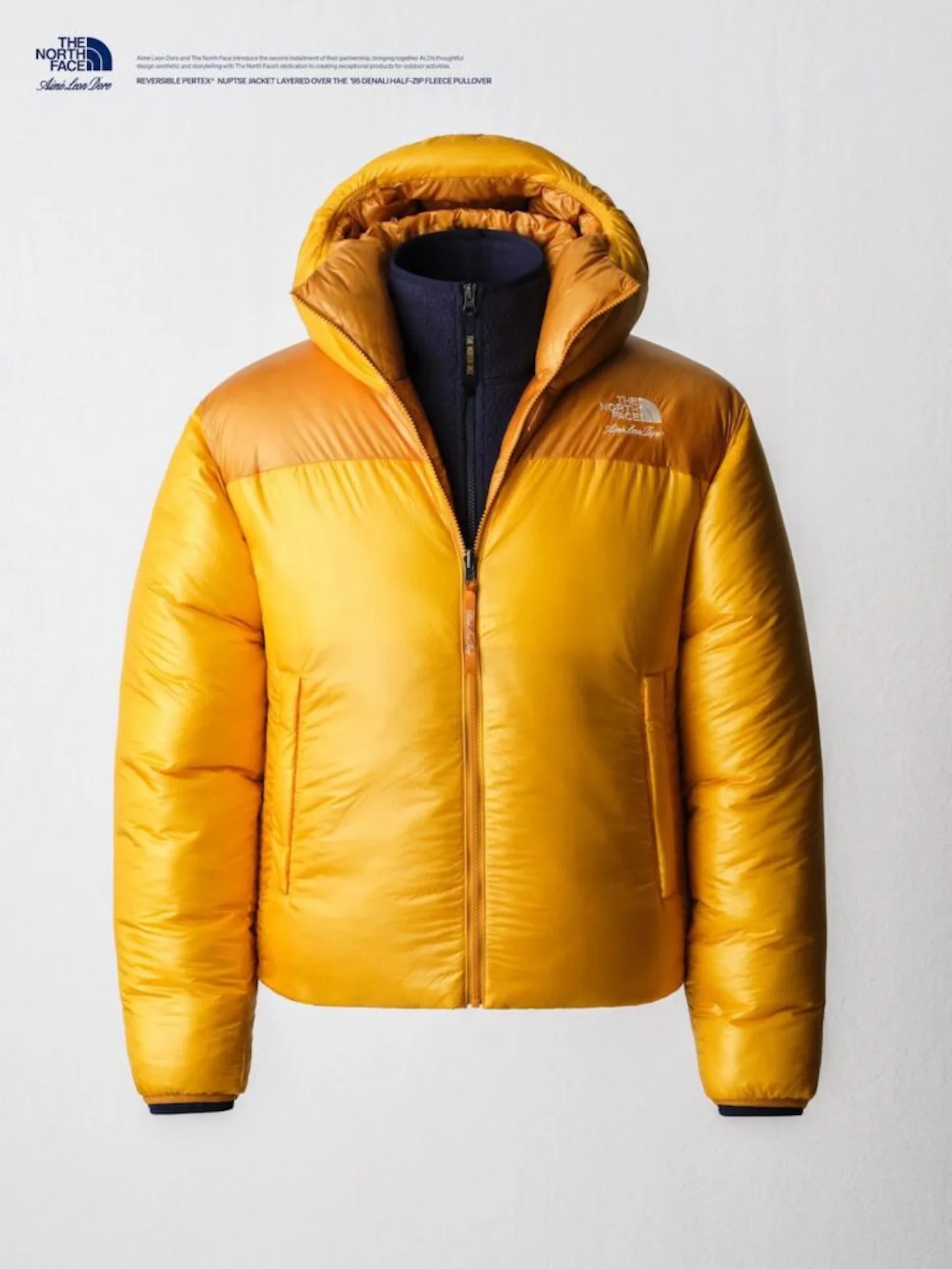 flat-lay, gold puffer jacket with navy fleece collar beneath, logo on chest, Fall/Winter 2026 Collection