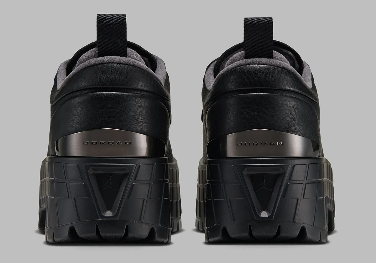 heel view, pair of black leather shoes with gunmetal jordan plate on lugged sole, Jordan 1 Brooklyn