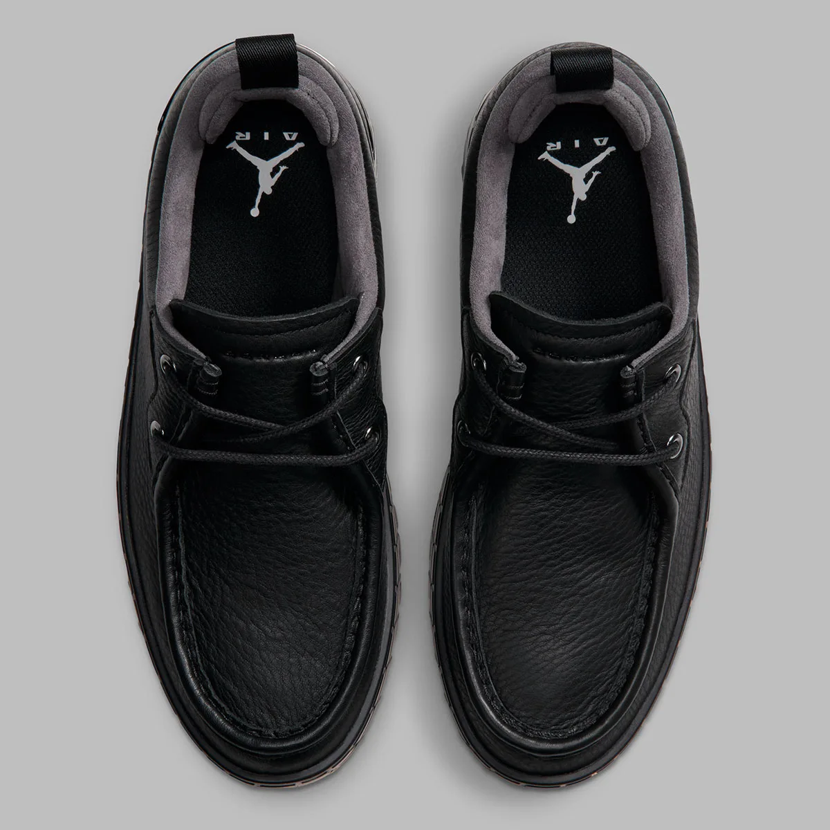top-down pair, black uppers with white jumpman air logo on black insole, Jordan 1 Brooklyn