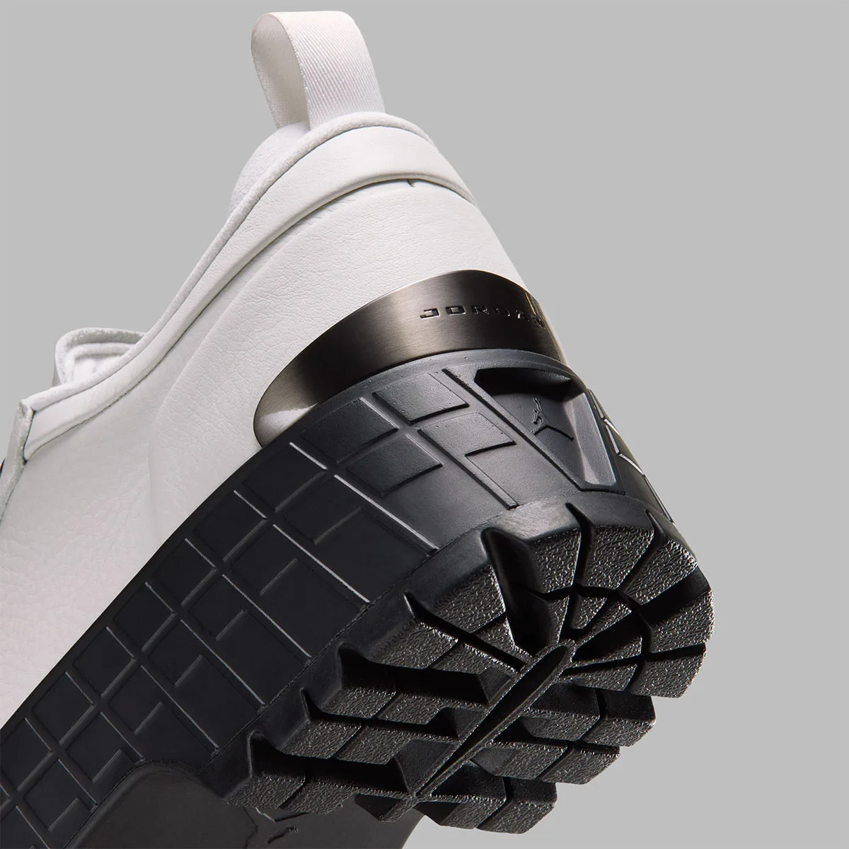 close-up heel detail, white leather with gunmetal jordan plate and black lug sole, Jordan 1 Brooklyn