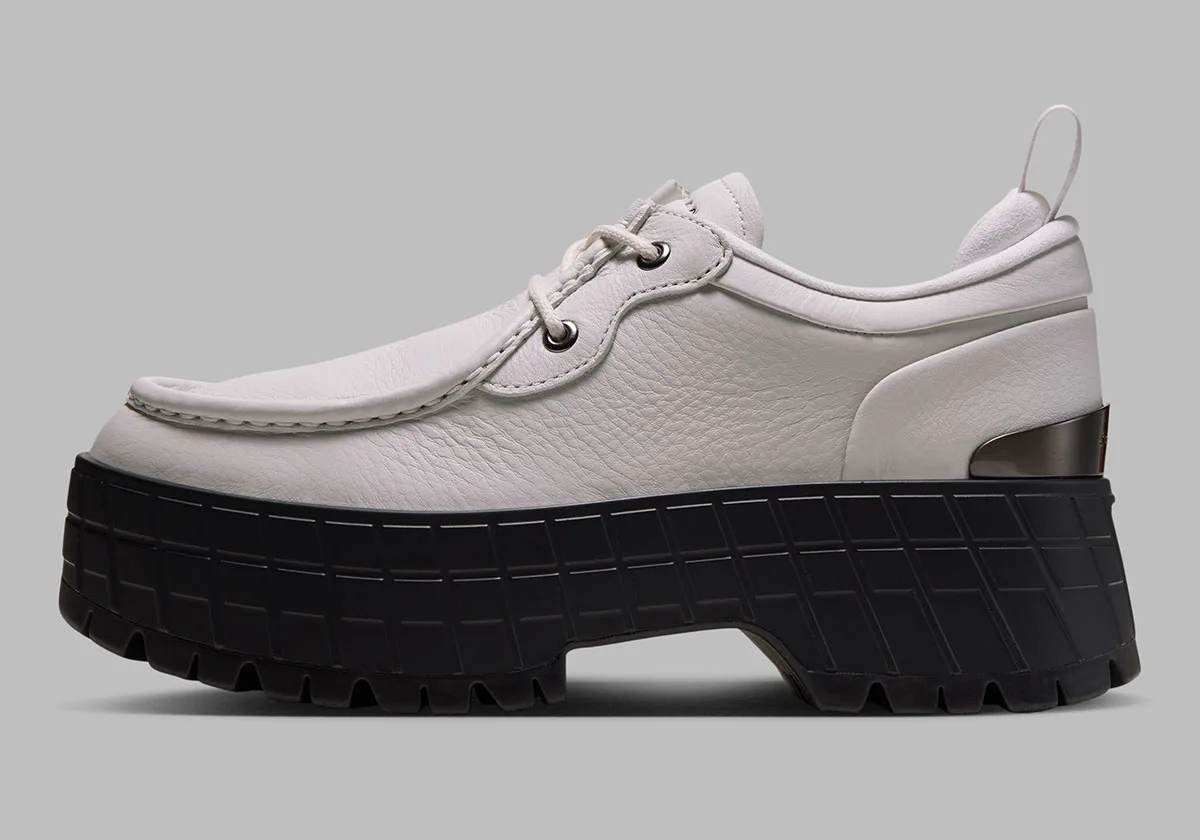 lateral view, white leather upper showing stitched moc toe and grey heel pull tab, Jordan 1 Brooklyn