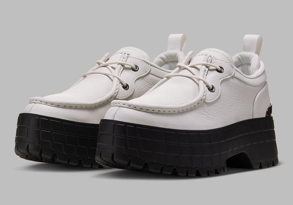 three-quarter pair view, white leather uppers on chunky black lugged soles, Jordan 1 Brooklyn